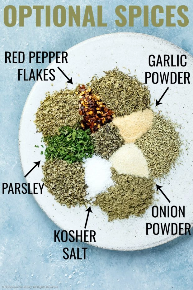 Overhead photo of optional ingredients in Italian seasoning neatly arranged on a plate with the name of each ingredient written out next to it.