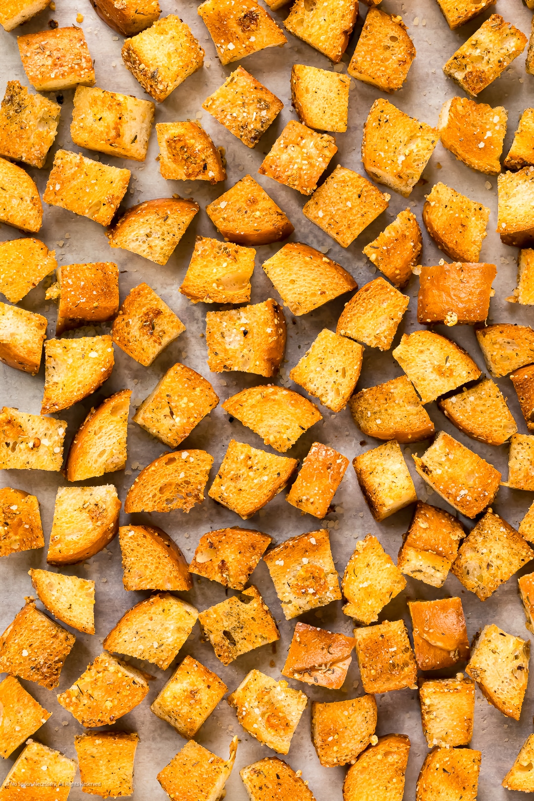 Close-up photo illustrating the crispy texture of croutons baked in the oven.