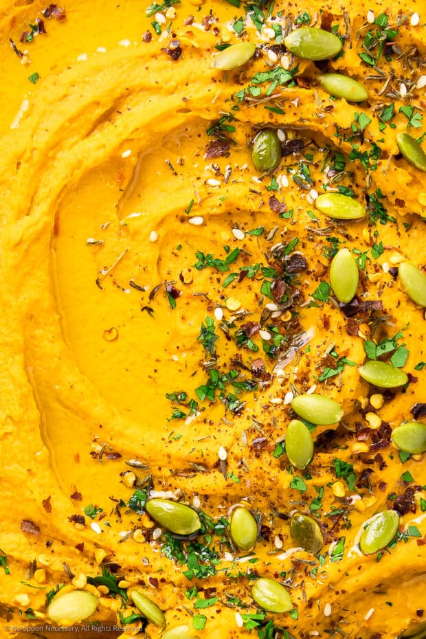 Close-up photo of showing the creamy texture of sweet potato hummus recipe.