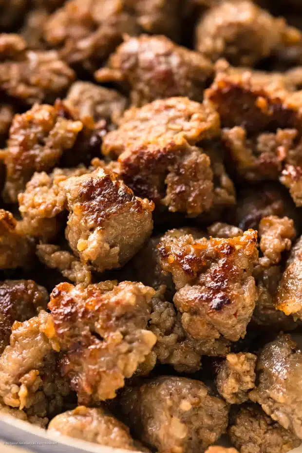 Close-up photo of cooked and crumbled Italian sausage.