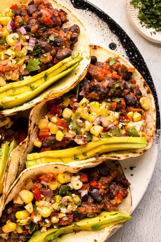 Overhead photo of three bean tacos with corn salsa.