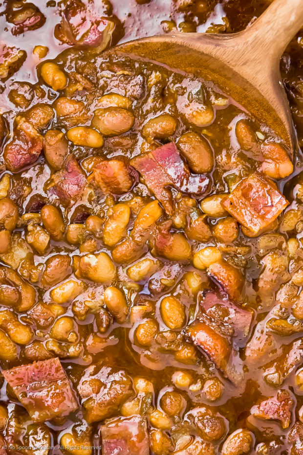 Close-up photo of homemade baked beans with cooked bacon.