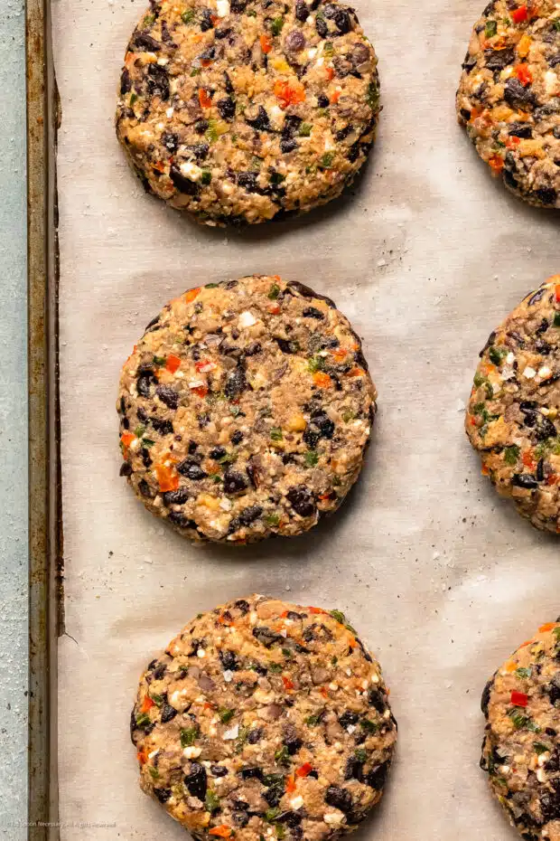 Photo of shaped, homemade black bean patty with vegetables.