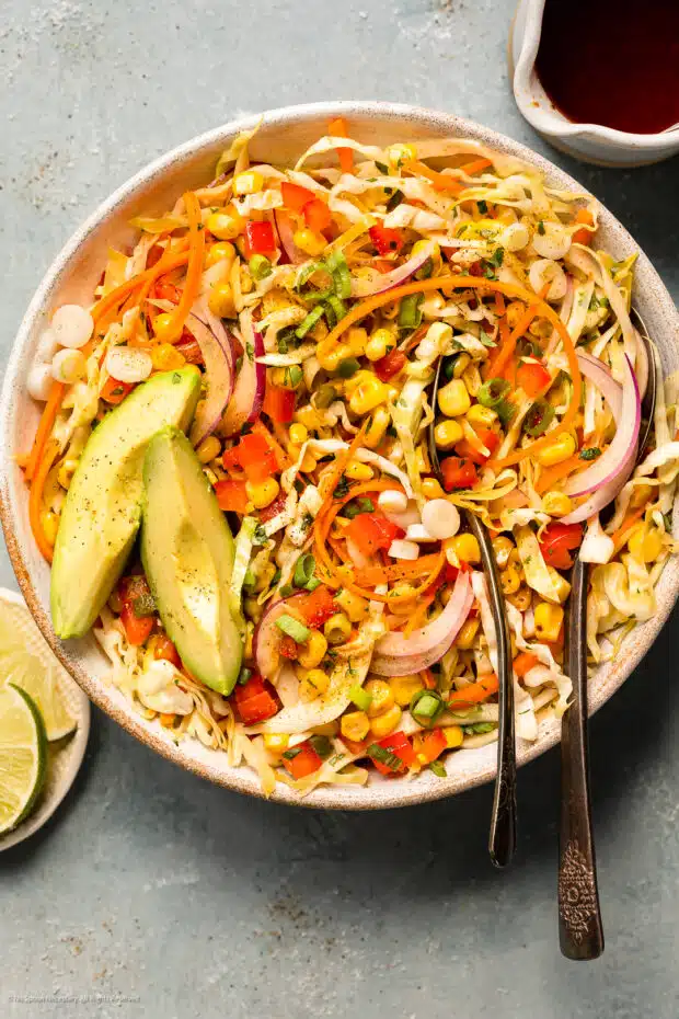 Overhead photo of cabbage coleslaw with mexican dressing in a white bowl.