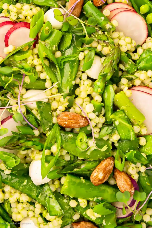 Close-up photo of veggie couscous salad with pesto dressing.