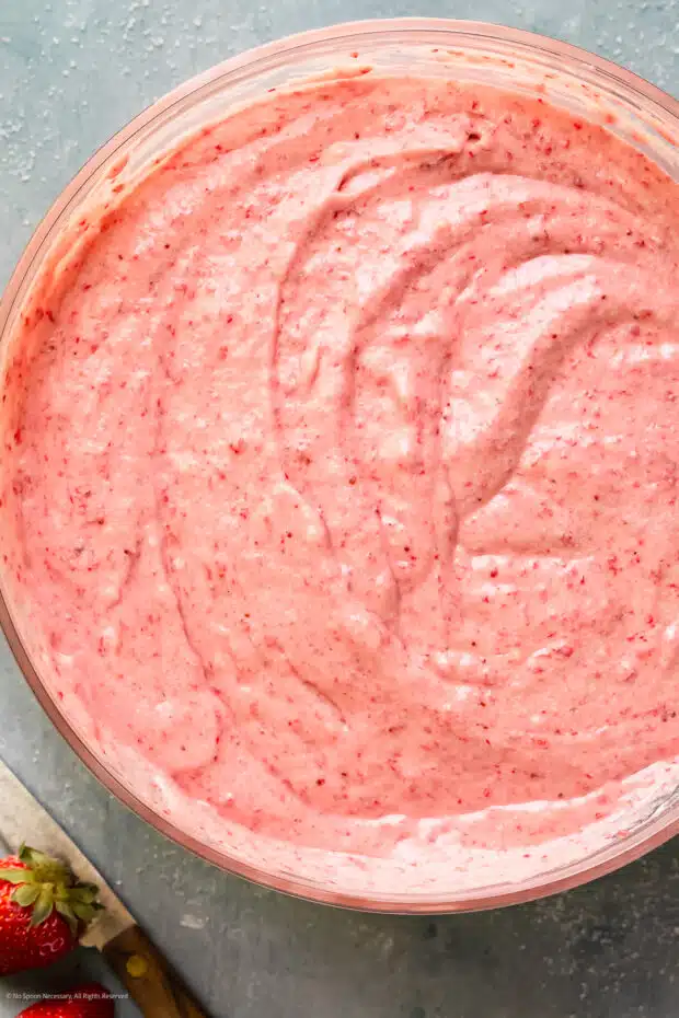 Overhead photo of pink cake batter made from scratch in a large mixing bowl.