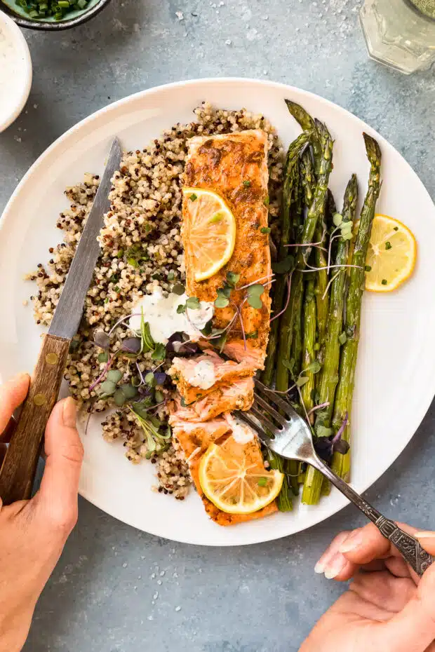 Overhead photo of baked salmon at 425 with asparagus and quinoa on a dinner plate.