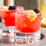 tray of blackberry bramble cocktails with garnish