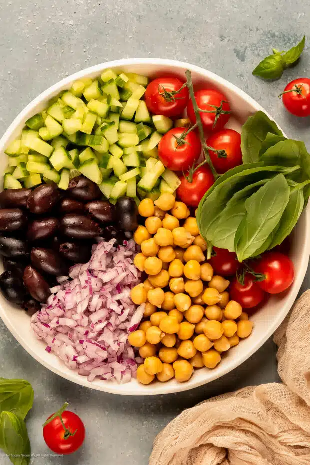 Photo of the all the ingredients in a greek orzo salad.
