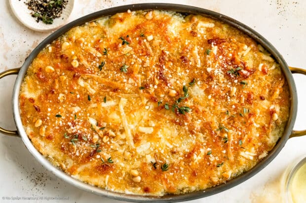 Overhead photo of brussels sprouts gratin with cheese in a casserole pan.