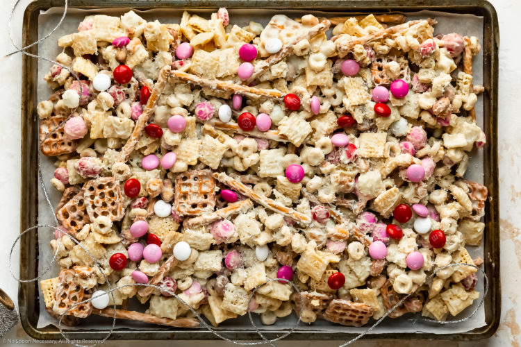 Overhead landscape photo of Sweet Chex Mix on a parchment-paper lined sheet pan.