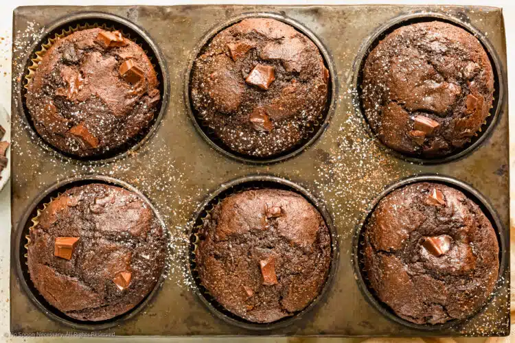 Overhead photo of chocolate muffins in a muffin baking tin.