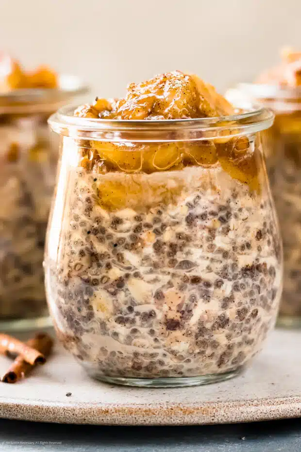 Photo of chia oats overnight with banana topping in a glass jar.