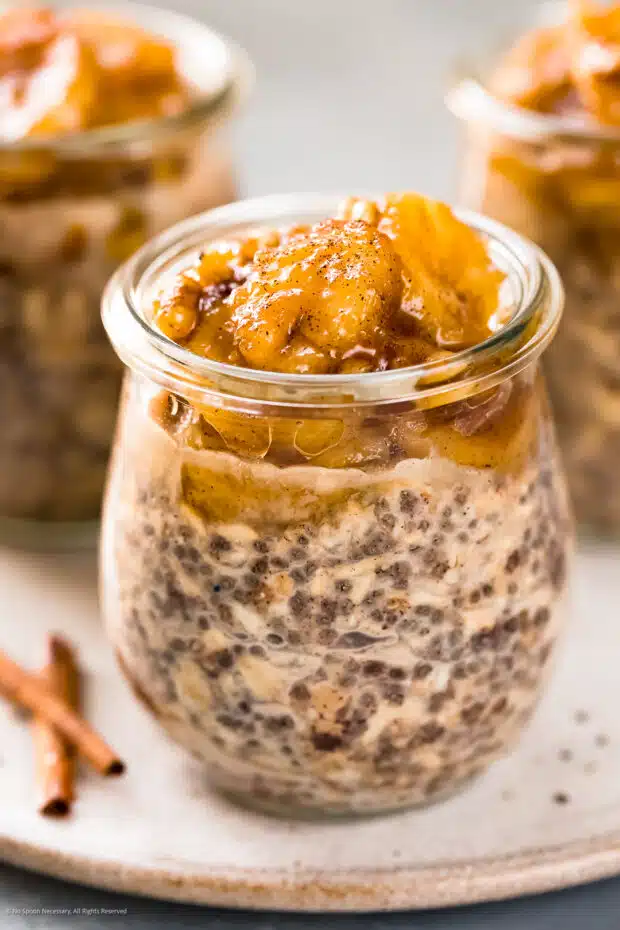 Angled photo of the banana topping on a jar of overnight oats with chia.