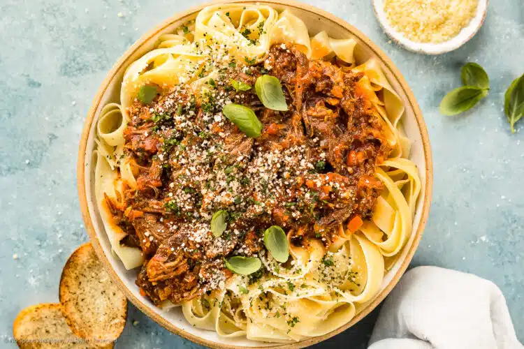 Overhead photo of slow cooker short ribs bolognese with pasta.