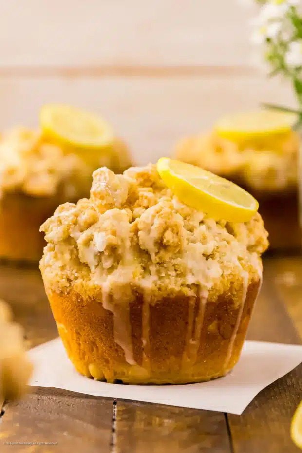 Straight on photo of three lemon muffins with glaze.