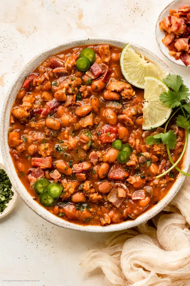Overhead photo of cooked beans in Mexican style with chorizo and cilantro. 