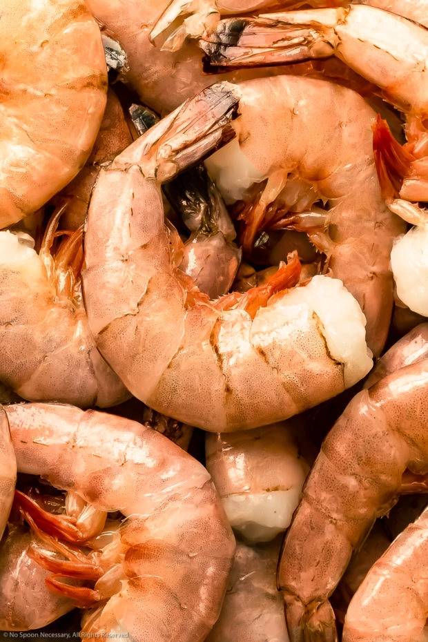 Overhead, close-up photo of fresh jumbo pink shrimp prior to peeling and deveining.