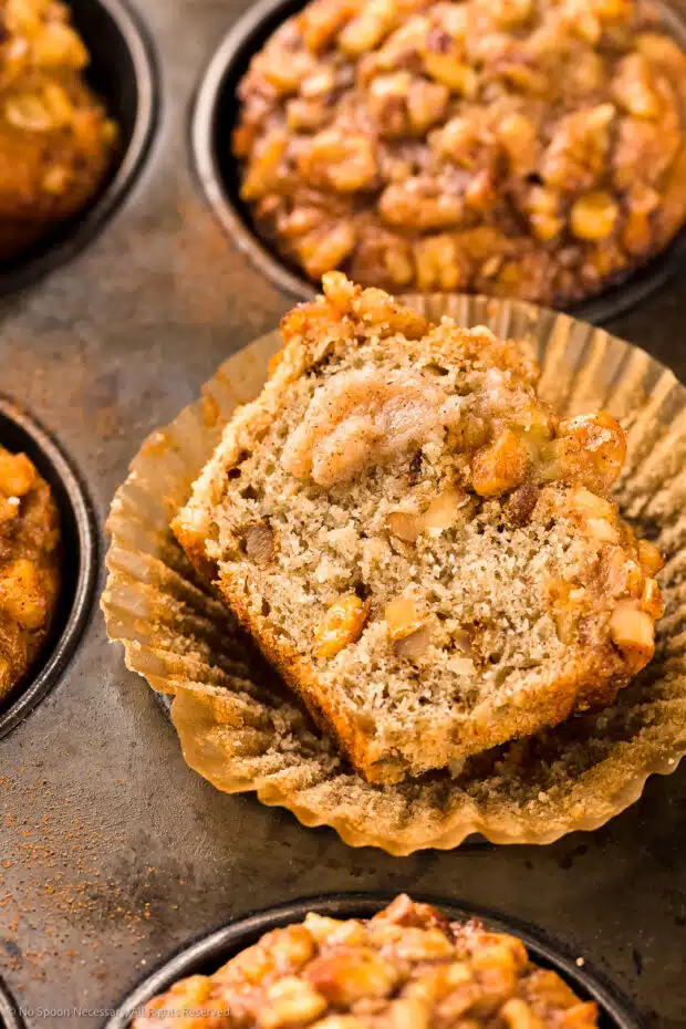 Close-up photo of a half of Muffin with banana, nut and a dollop of cinnamon honey butter.