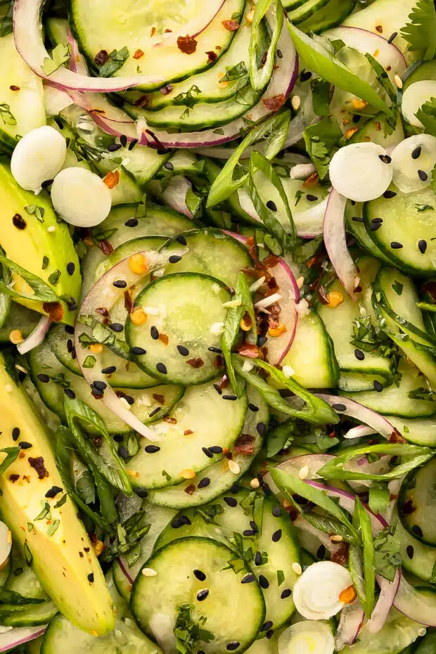 Close-up photo of cucumber Asian salad with sesame seeds.
