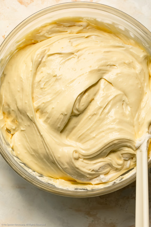 Overhead photo of prepared instant banana pudding in a large glass mixing bowl.