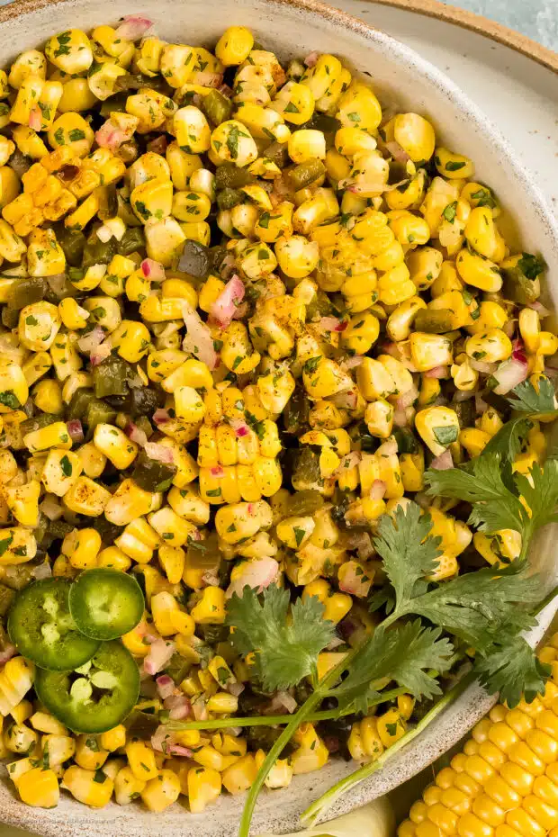 Close-up photo of prepared recipe for roasted corn salsa with cilantro and jalapenos.