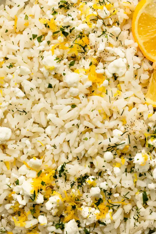 Close-up photo of the fluffy texture of lemony rice with fresh zest and dill.