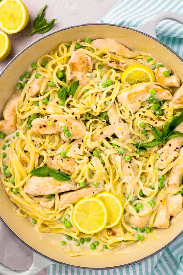 Overhead photo of lemon chicken with pasta in a large skillet.