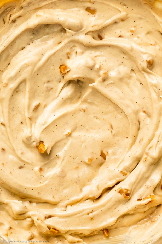 Overhead, close-up photo of sweet cream cheese dip for fruit and cookies.
