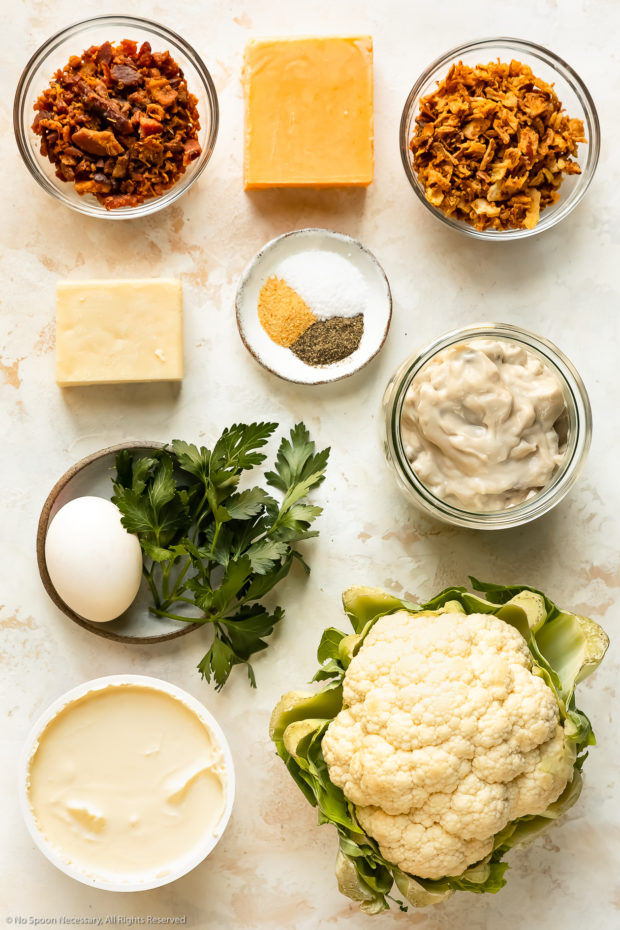 Overhead photo of all the ingredients you need to make cauliflower casserole neatly organized into individual bowls.