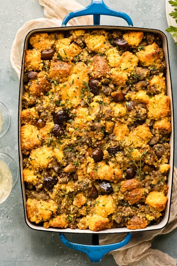 Overhead photo of baked chestnut stuffing in a blue casserole dish.