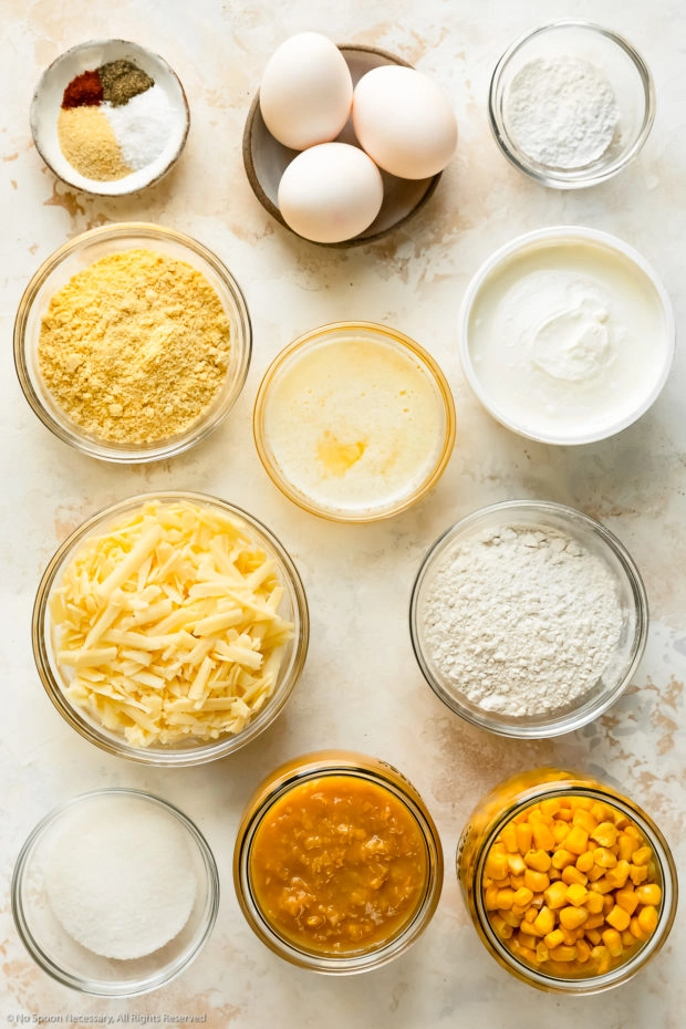 Overhead photo of all the ingredients in a creamy corn casserole recipe neatly arranged in individual bowls.