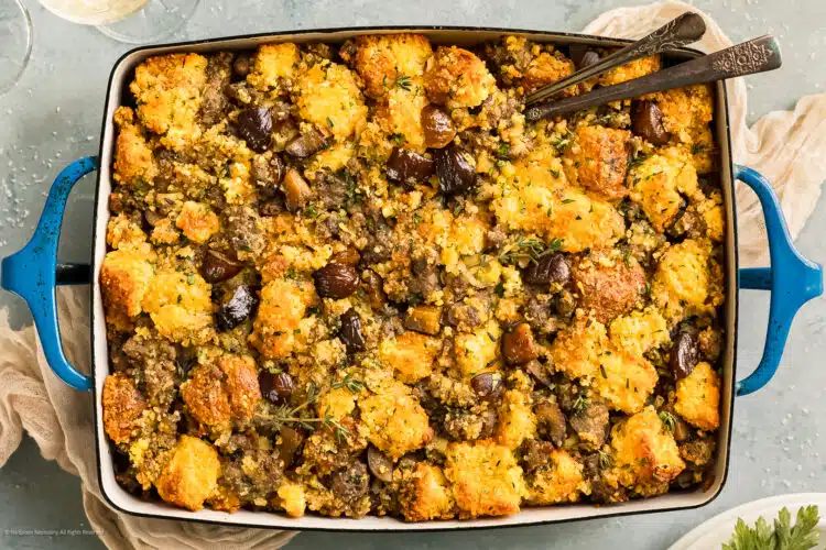 Overhead photo of perfectly baked chestnut stuffing in a blue casserole dish.