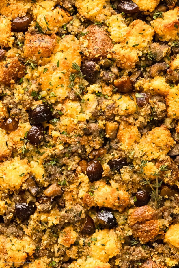 Close-up photo of baked cornbread dressing with chestnuts and sausage.