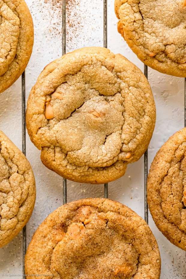 Overhead photo of a soft cinnamon cookie on a wire cooling rack.