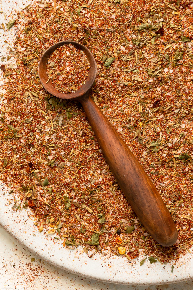 Close-up, overhead photo of homemade cajun seasoning spilled out onto a plate. 