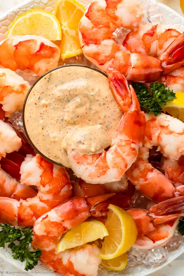 Overhead photo of a bowl of cajun sauce in the middle of a seafood platter.