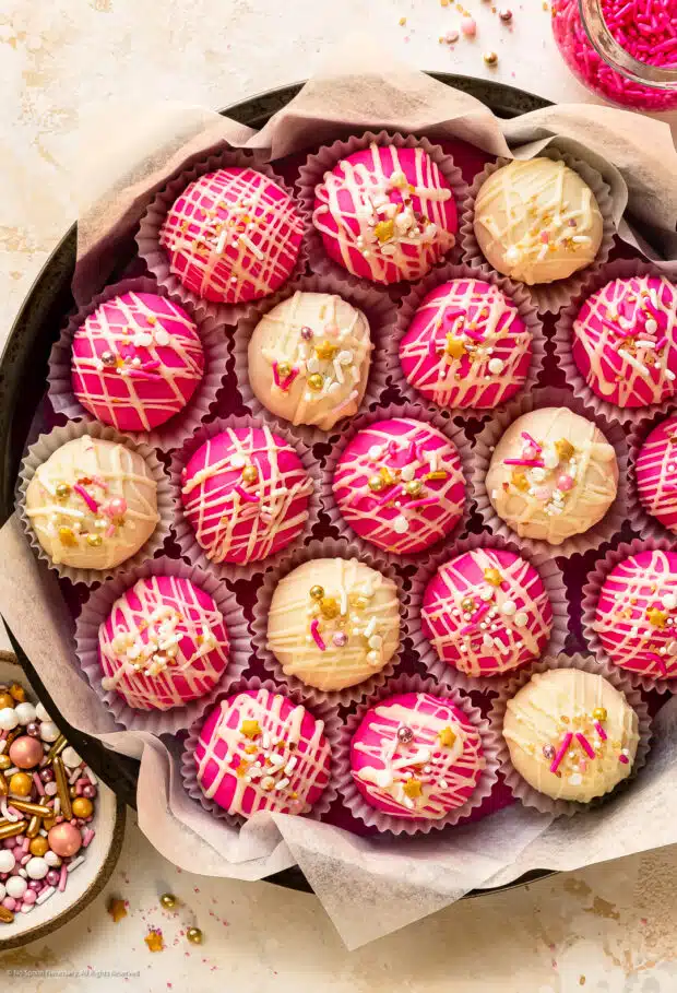 Overhead photo of 19 decorated cake bites from this cake ball recipe.