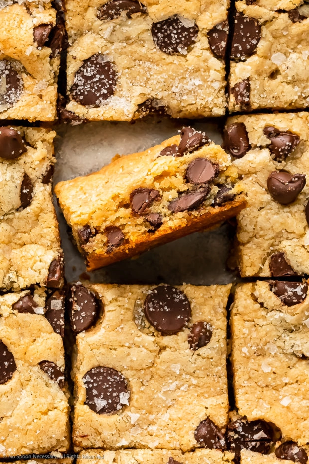 Close-up overhead photo of the chocolate chips and soft, chewy interior of a cookie bar made from cake mix.