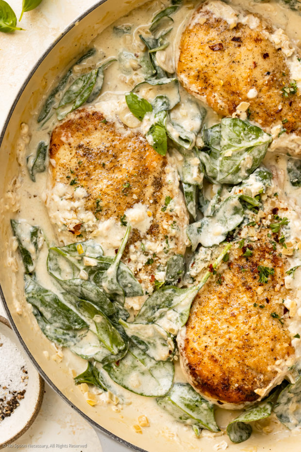 Overhead photo of Florentine Chicken breasts in a creamy sauce with spinach.