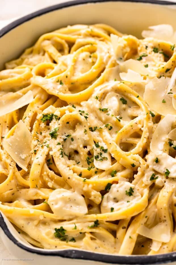 Angled photo of pasta cream cheese in a white serving bowl.