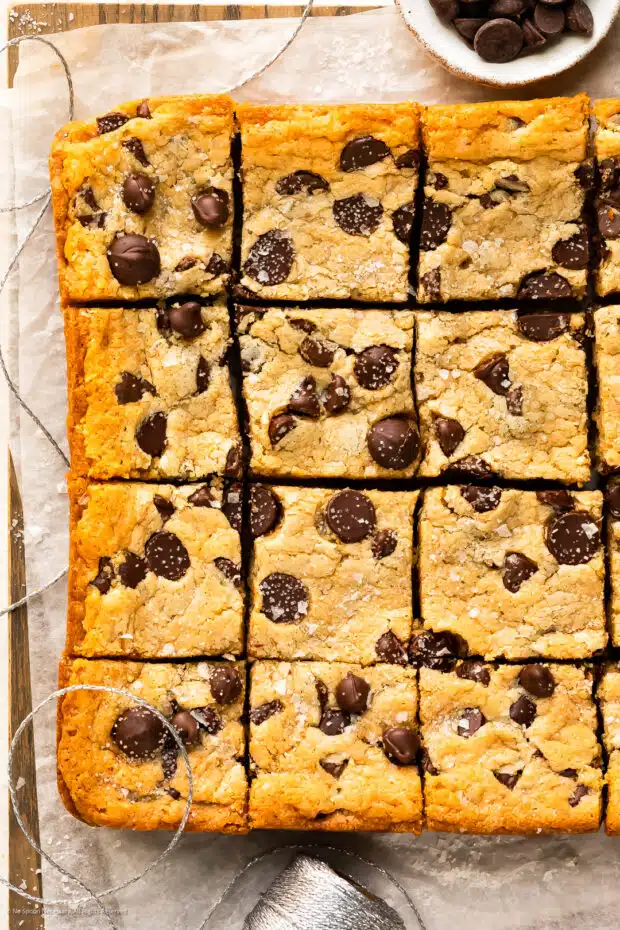 Overhead photo of chocolate chip bar cookies from a cake mix on a wood serving tray.