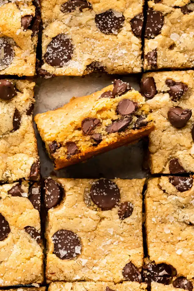 Close-up overhead photo of the chocolate chips and soft, chewy interior of a cookie bar made from cake mix.