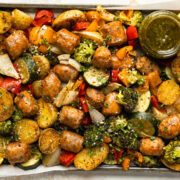 Overhead photo of a sheet pan with sausage and veggies.