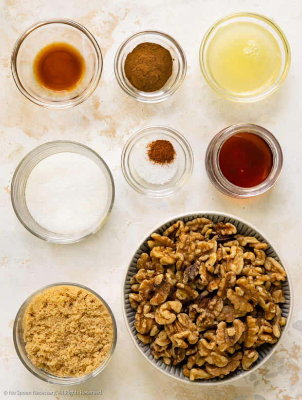 Overhead photo of all the ingredients in the candied walnuts recipe neatly organized in individual glass bowls.