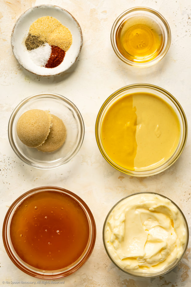 Overhead photo of all the ingredients to make honey mustard recipe neatly arranged into individual bowls.