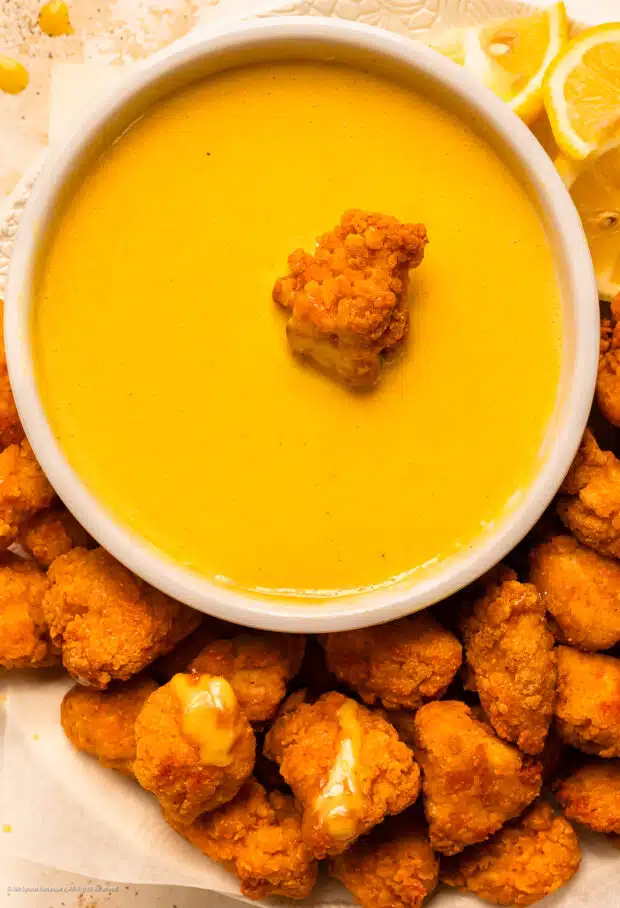 Overhead photo of a platter of chicken nuggets with a bowl of dijon mustard for dipping.