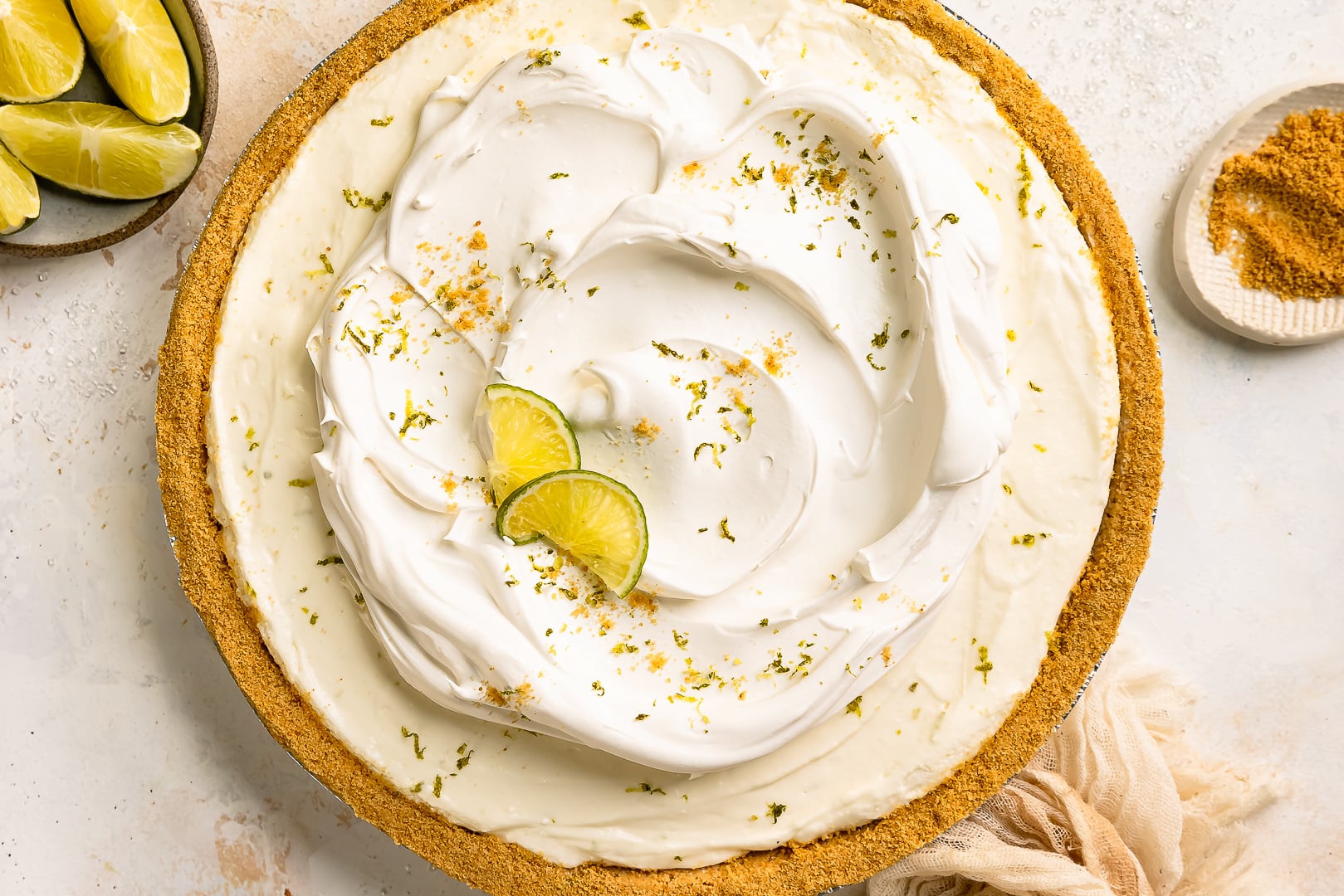 Overhead photo of no bake key lime pie decorated with cool whip and lime zest.