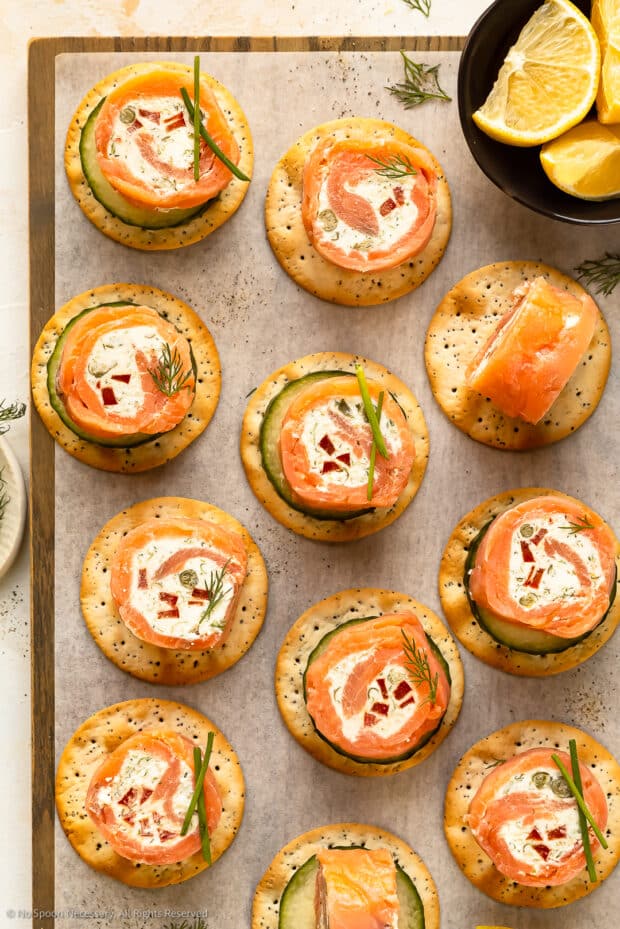 Overhead photo of easy bite size appetizer with smoked salmon, fresh vegetables, dill and cream cheese.