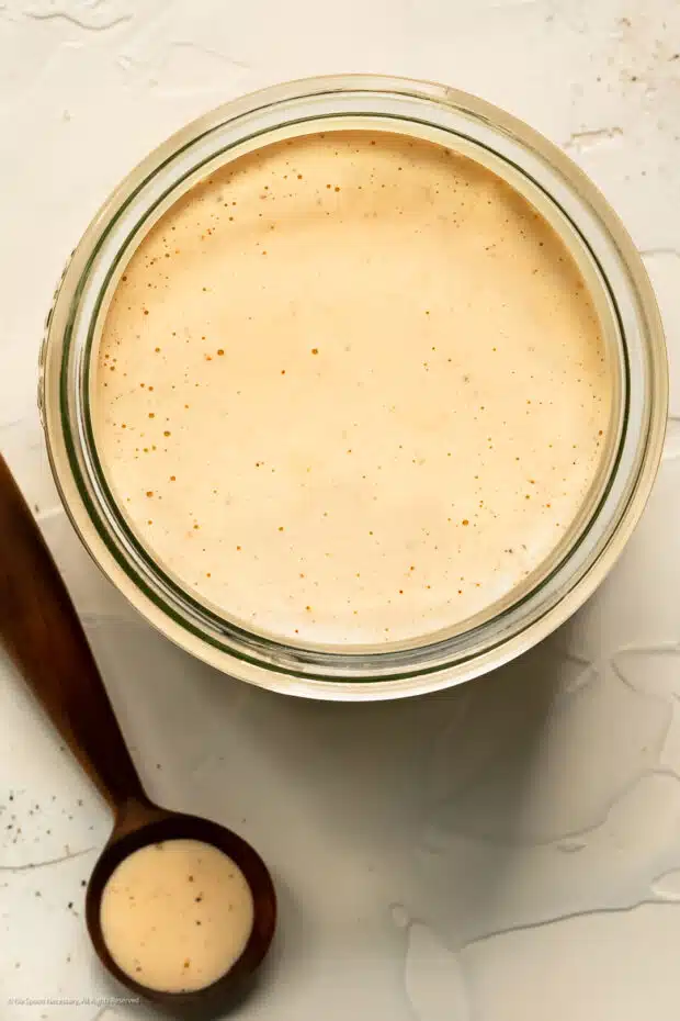 Overhead photo of a jar of creamy dressing for tuna salad with macaroni.